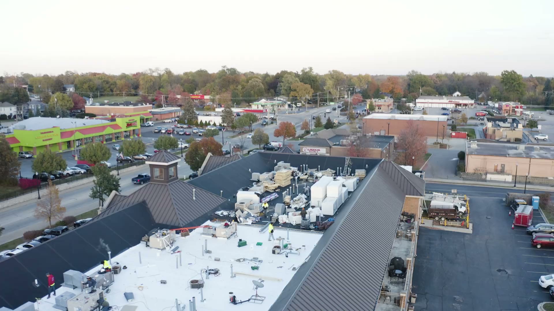 Commercial low-slope roofs across a business district