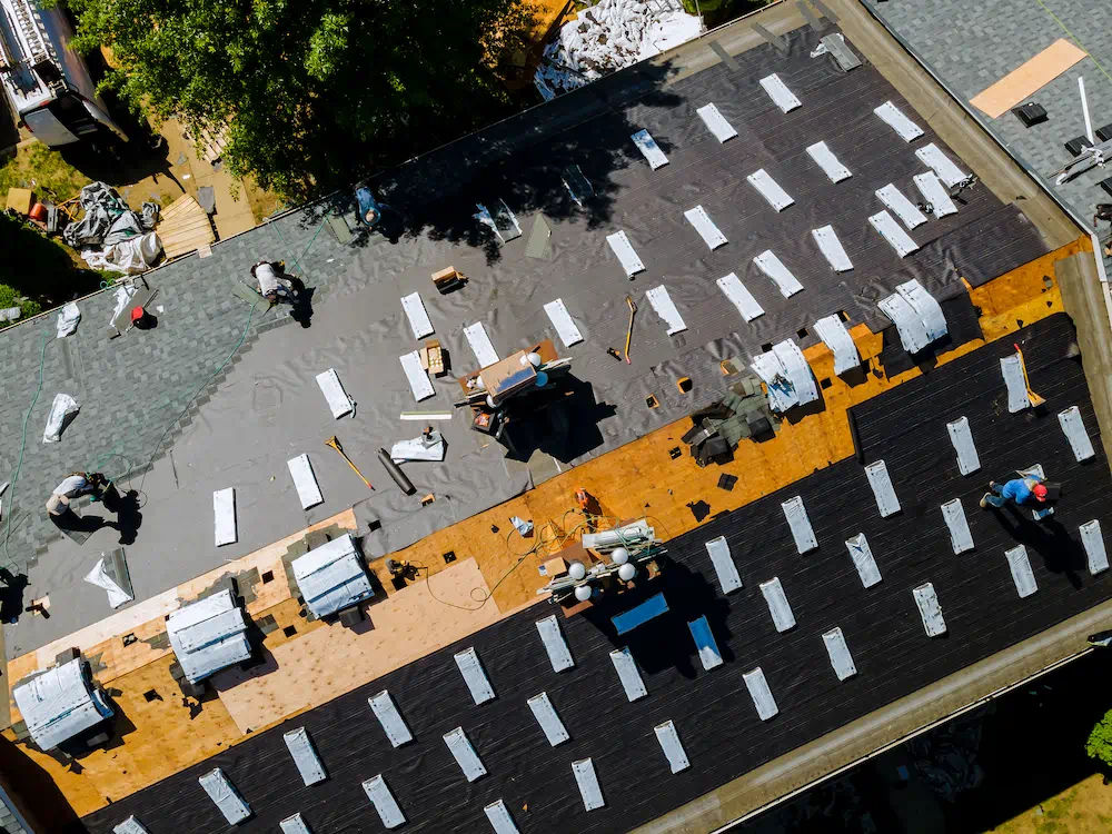 MADE crew installing a dark shingle roof viewed from above