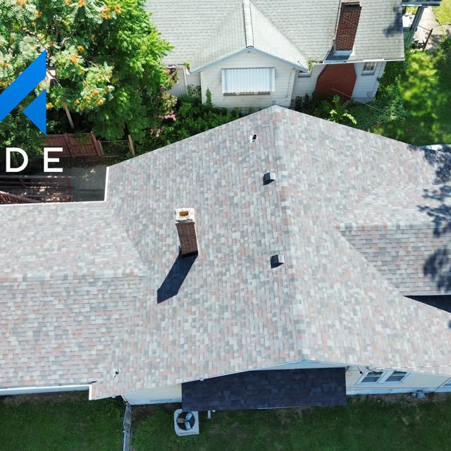 Aerial view of a shingle roof with chimney flashing
