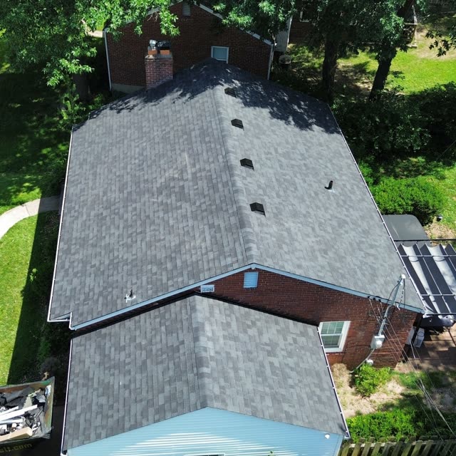 Completed dark roof on a brick home