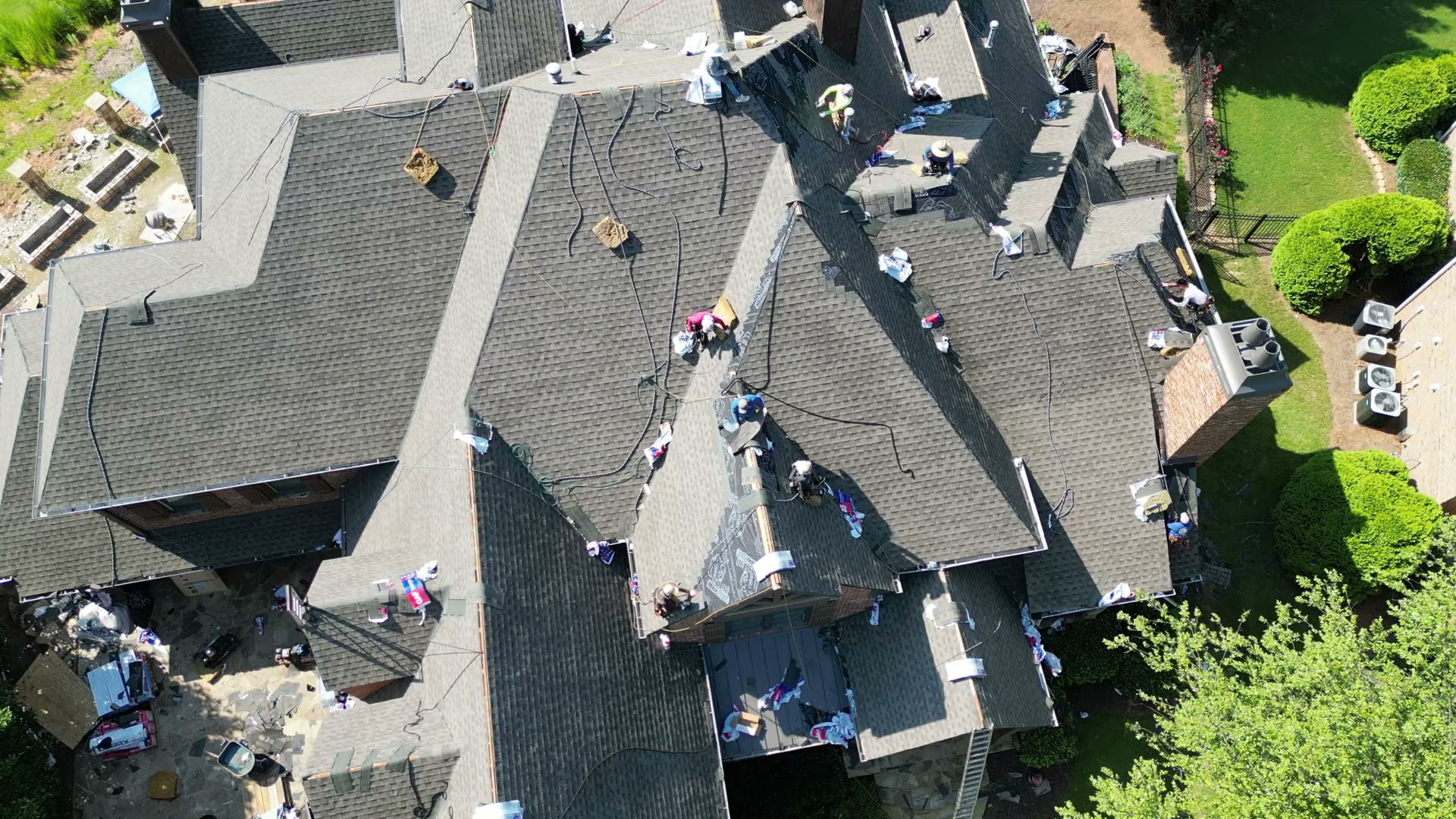 Large residential roof replacement in progress from the air