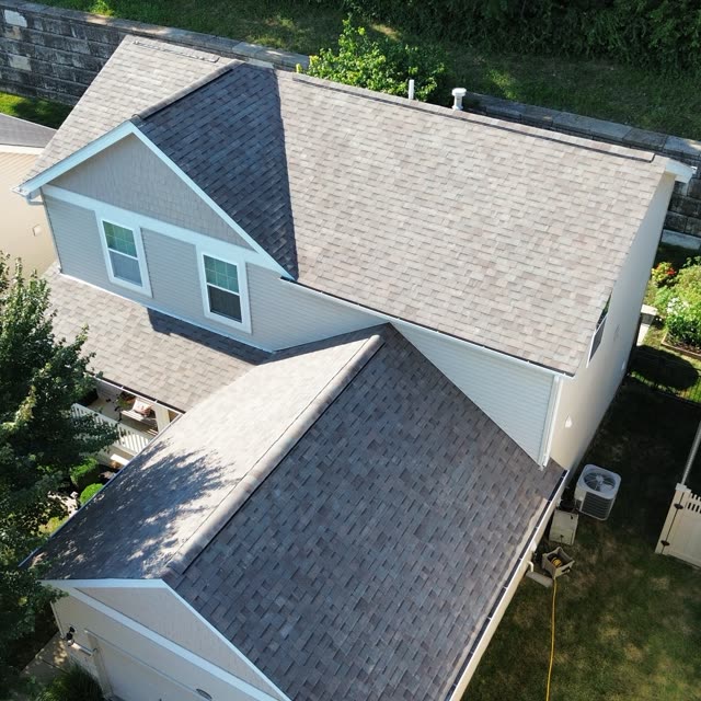 Adjacent homes with completed shingle roofing